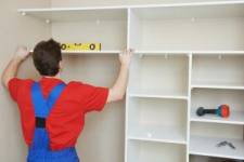 Man installing shelves for storage