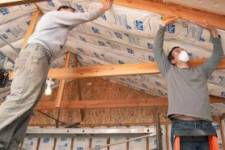 Workers insulating a garage